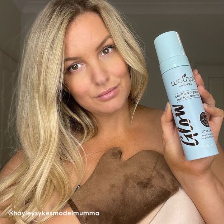 Model holding Wotnot's certified organic self tan mousse by Wotnot Naturals